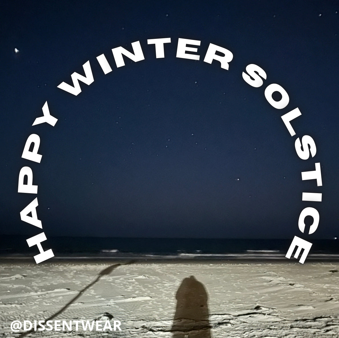 Husband and wife shadows at the ocean’s edge on a cold winter night with only the light of the stars above