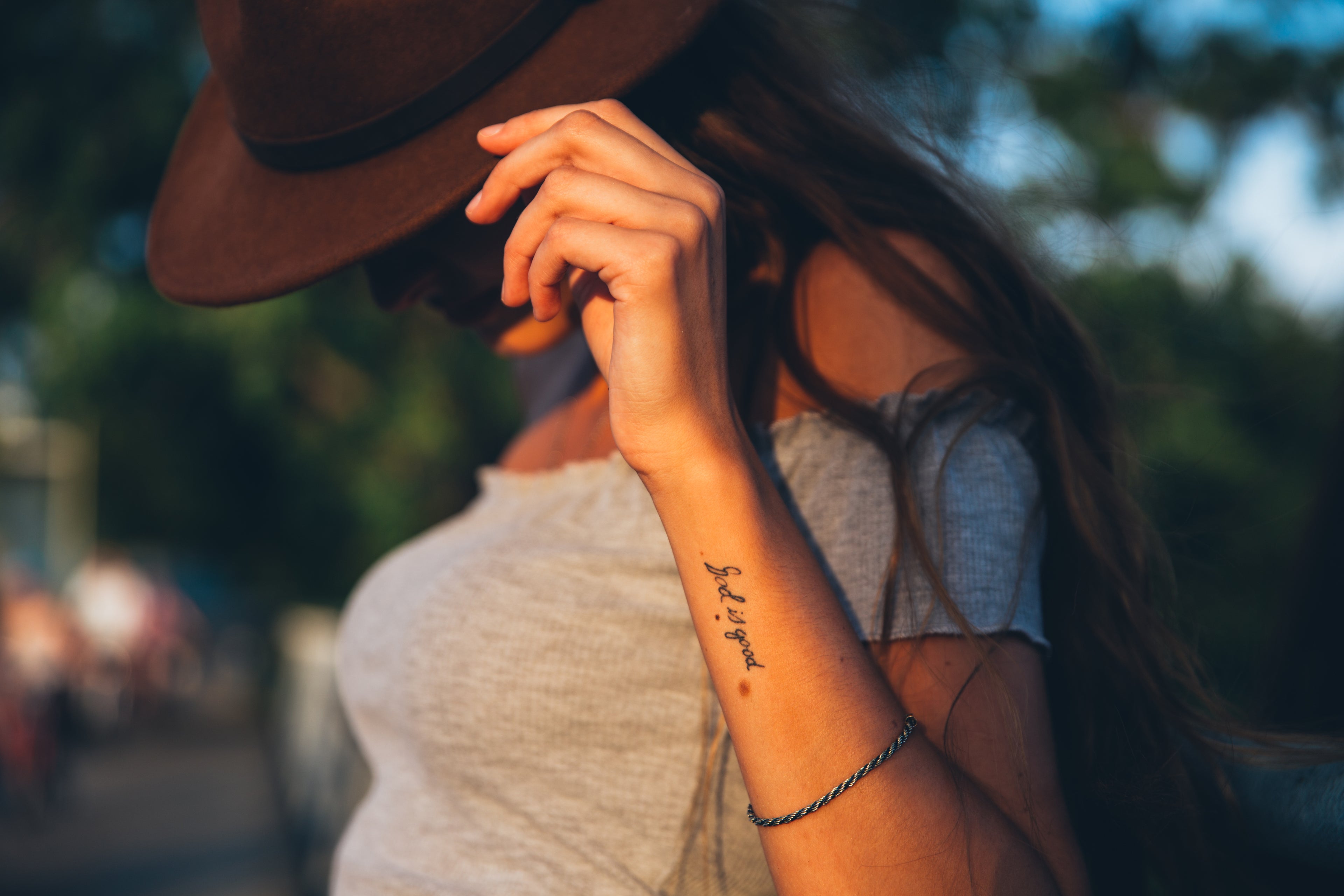 young woman in a hat outside in dissent wear brand