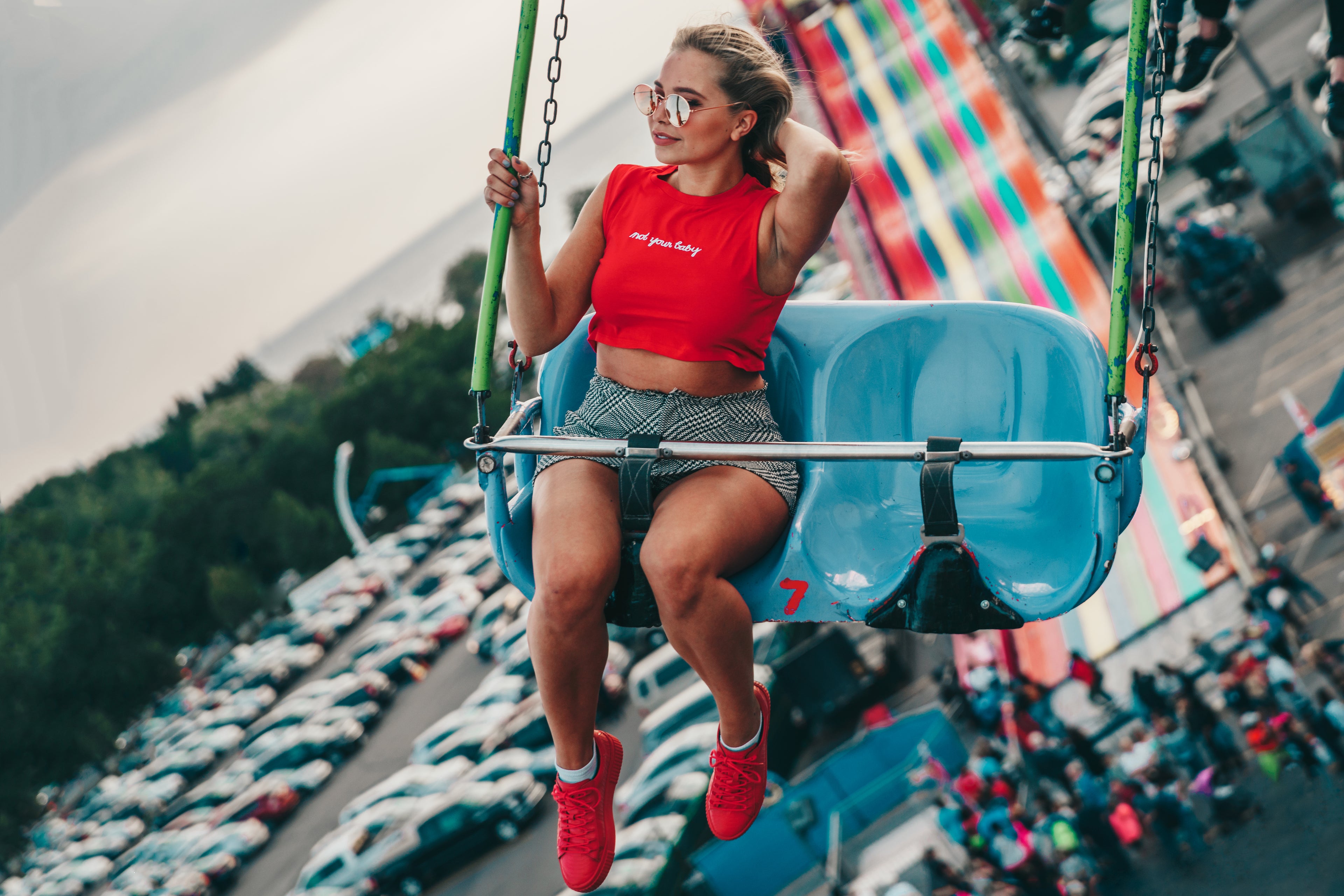 Trendy woman on fair carnival ride